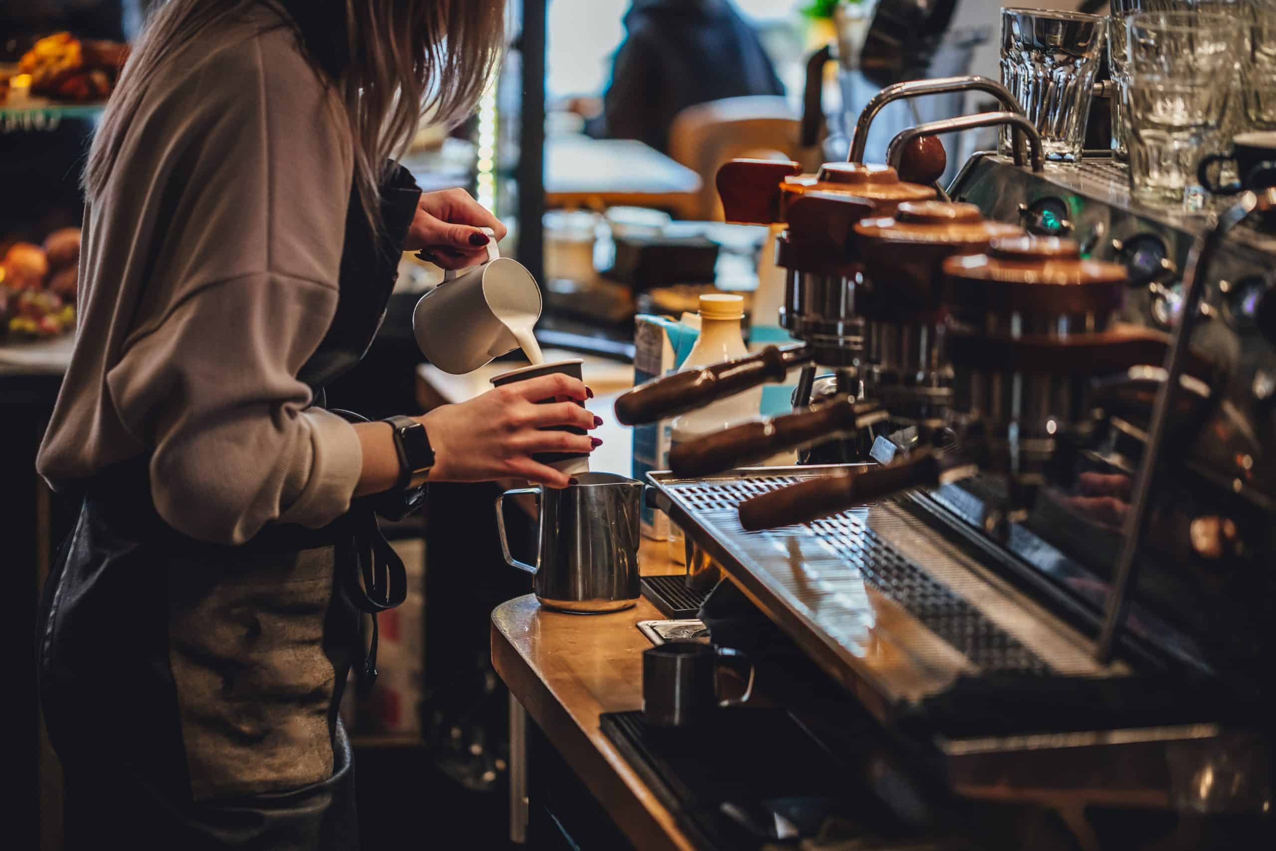 Professional barista making a cappuccino A professional barista making a cappuccino in a specialty coffee shop